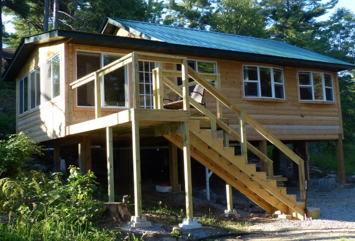 The three season room, at left, has large windows on the front and side walls.  Privacy is easy to get by lowering the blinds which provide soft light.