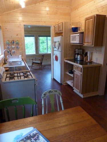Full kitchen with gas range, refrigerator, microwave, coffee maker, toaster, and fully stocked with dishes, pots, pans, and utensils.