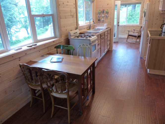 The kitchen table with views of White Iron Lake and the kitchen which opens onto the three season room.